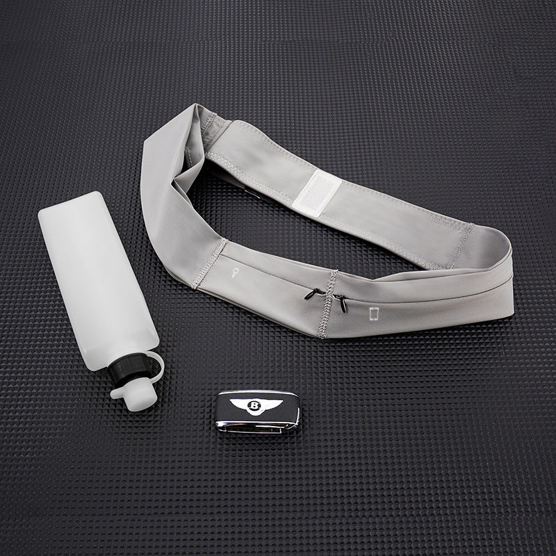 Gray waist bag with a water bottle and phone on a black textured surface