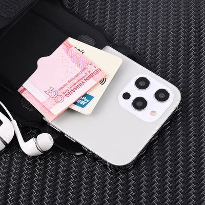 Phone case with currency and earbuds on a textured black surface